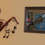 Wall sculpture of a saxophone and photo of the RCA Victor Dog